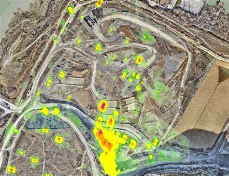 Methane Cloud Detection with Aerial Heatmap Overlay Aerial map showing methane gas concentrations as heatmap overlays across a landfill site.