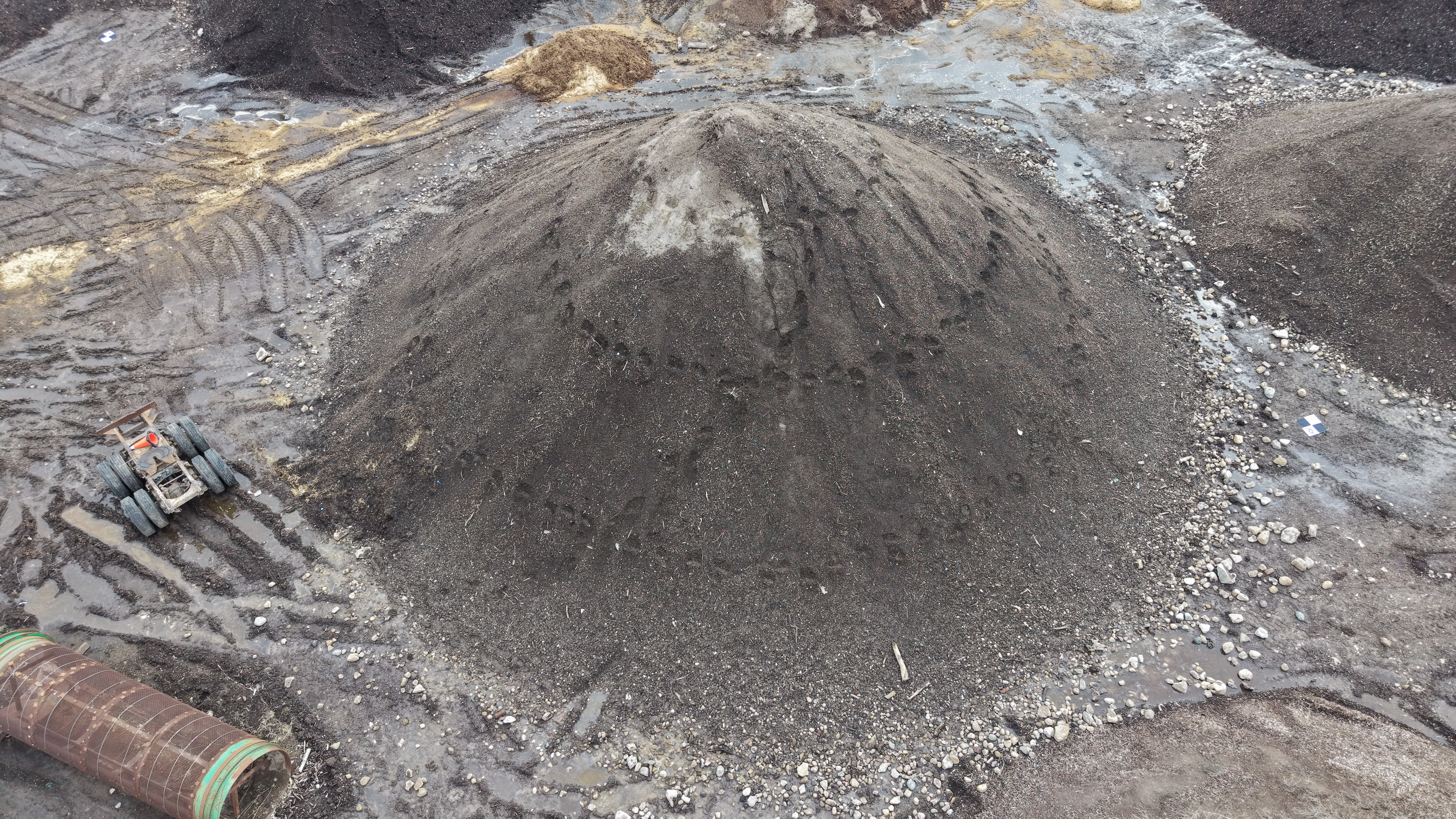 Aerial drone view of a large aggregate stockpile used for volumetric volume calculation in Ontario