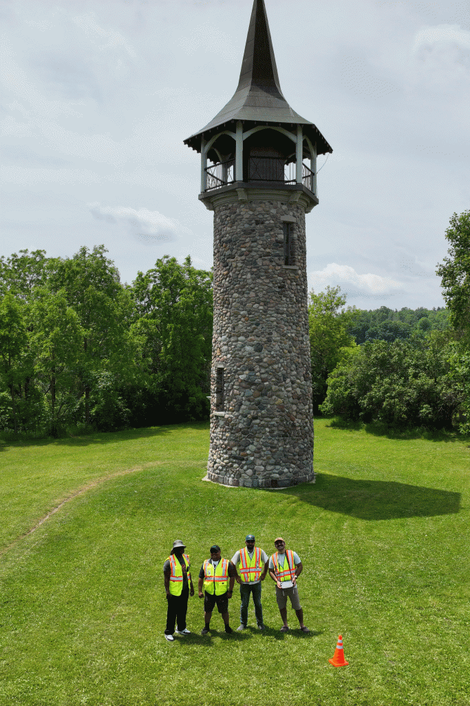 Trillium Imaging team standing at the base of the Waterloo Pioneer Memorial Tower in Kitchener before a drone photogrammetry flight