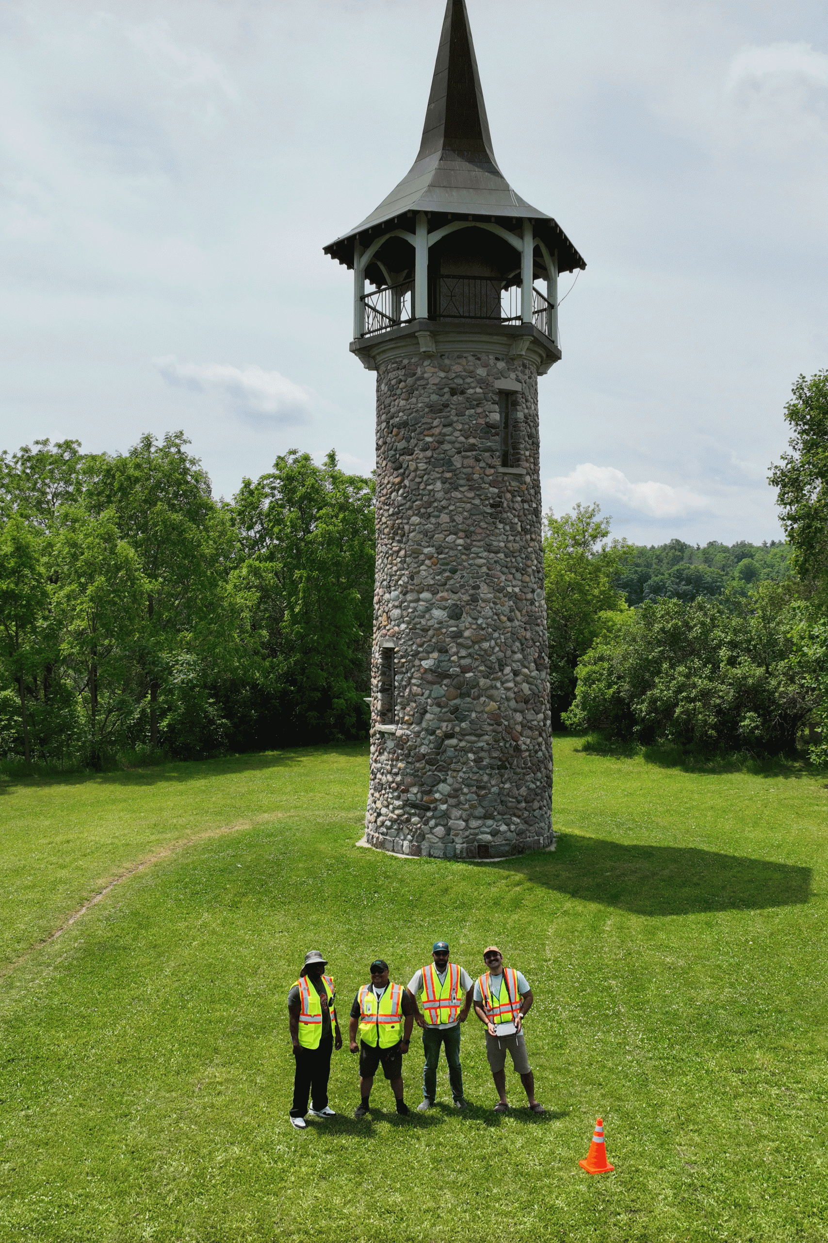Trillium Imaging team standing at the base of the Waterloo Pioneer Memorial Tower in Kitchener before a drone photogrammetry flight